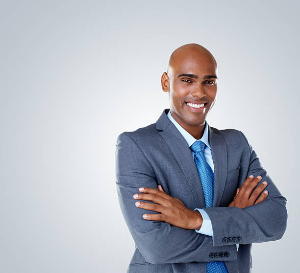 istock Business man with hands folded against colored background 183251257