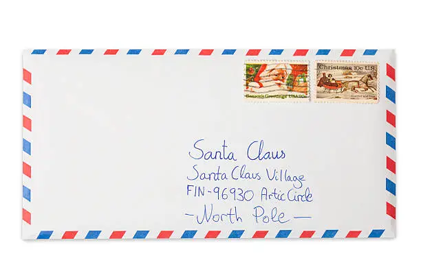 Letter to Santa Claus with his address written on it in a air mail envelope isolated on white background. Franked US Christmas stamps on it. This is an exclusive image and it can only be found in iStockphoto.