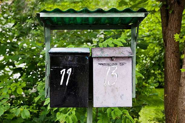 istock Two vintage painted mail boxes number eleven and thirteen. 183251337