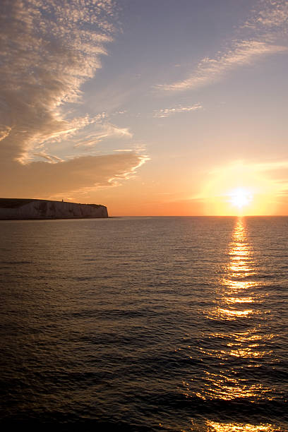 Channel ferry sunrise White cliffs of Dover sunrise from a cross channel ferry ferry dover england calais france uk stock pictures, royalty-free photos & images