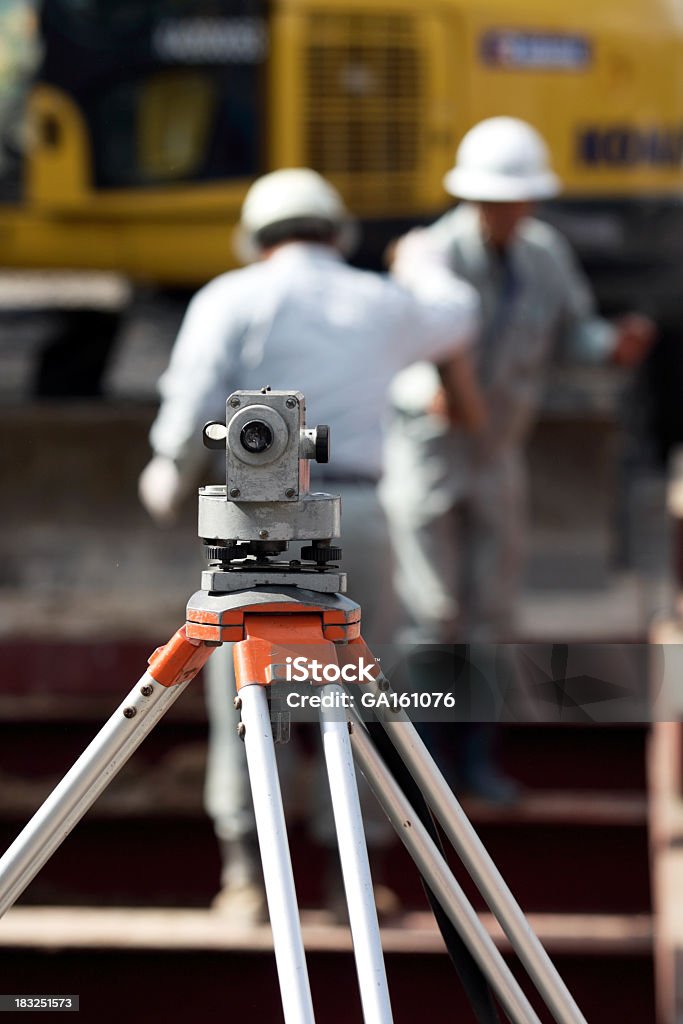 Man Using Dumpy Level Dumpy Level With Worker Behind Stock Photo - Download Image Now - Blue ...