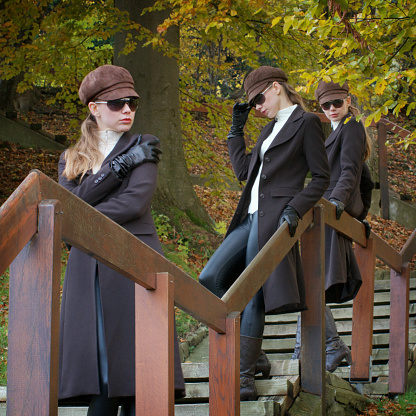 Fashionable triplets looking cool in an autumn scene.See