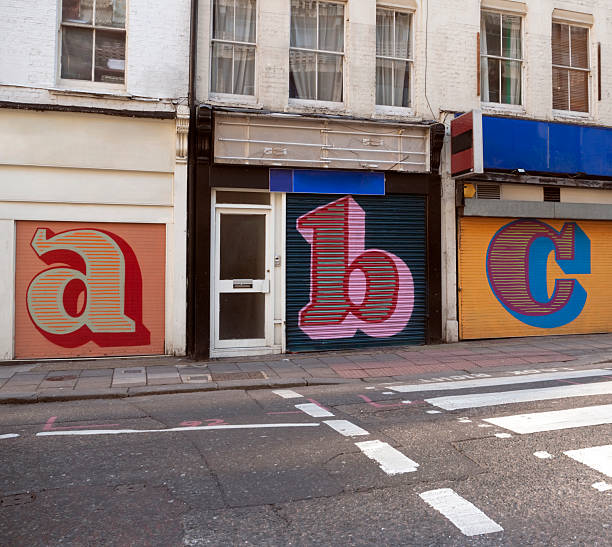 Store shutters letters Letters rendered on disused store shutters. alphabetical order photos stock pictures, royalty-free photos & images