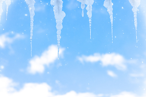 Icicles in front of a blue sky in winter