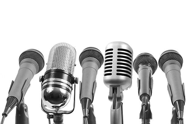 Multiple interview Six microphones isolated on white. The 4th from left is not a Shure mic.  microphone stand photos stock pictures, royalty-free photos & images
