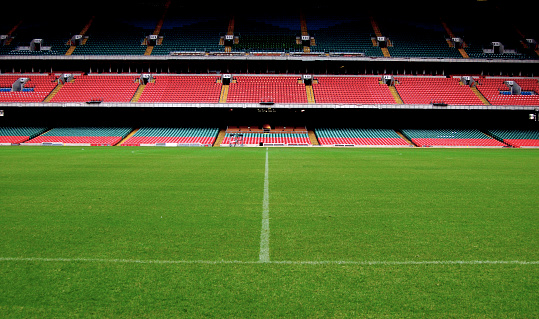 Football soccer ball on grass field on stadium. Sport