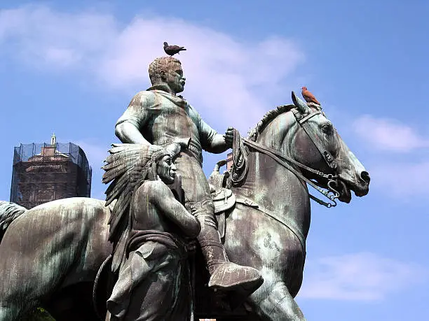 "Theodore Roosevelt on a horse with a Native American at his side. This is located outside the Museum of Natural History, New York City."