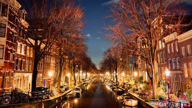 Amsterdam Grachten in December at Midnight. Amsterdam Downtown Cityscape Grachten View at Night. Amsterdam, Netherlands, Europe.
