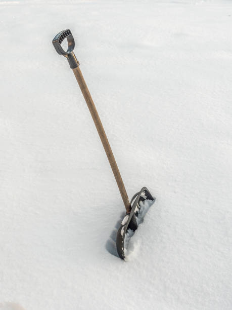 istock Snow clearing shovel driven into thick snow cover 1832538971