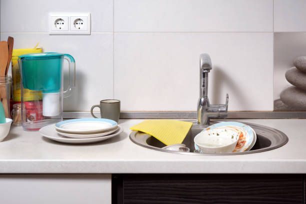 istock Kitchen sink with dirty dishes after dinner in a home interior. 1832541627