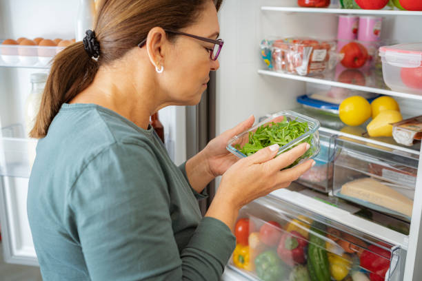 istock Woman notices unpleasant smell in fridge 1832541759