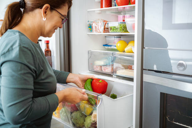 istock Close up on woman taking vegetables from fridge drawer 1832542169