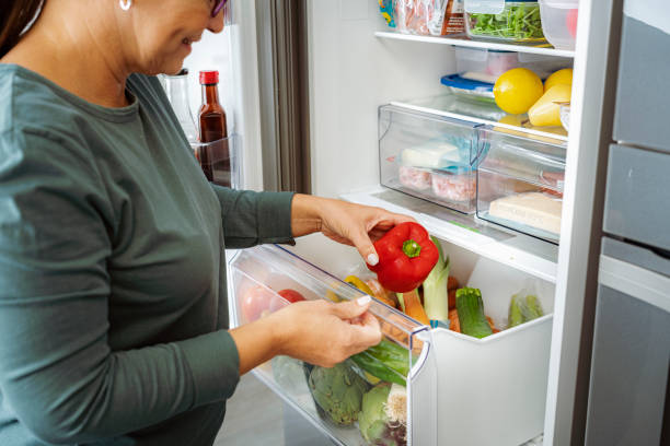istock Close up on woman taking vegetables from fridge drawer 1832542190