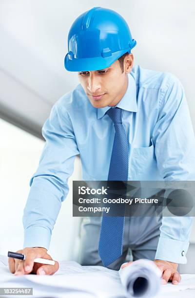 Smart Young Architect Working On Blue Prints Stock Photo - Download Image Now - 20-29 Years, 30-39 Years, Administrator