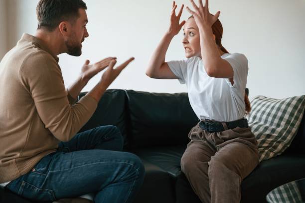 istock Side view of couple that are arguing. Sitting on sofa 1832545403