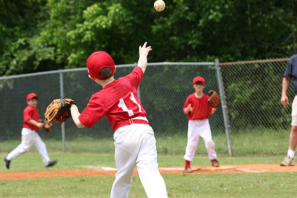 Play at First a little league play at first youth baseball and softball league photos stock pictures, royalty-free photos & images