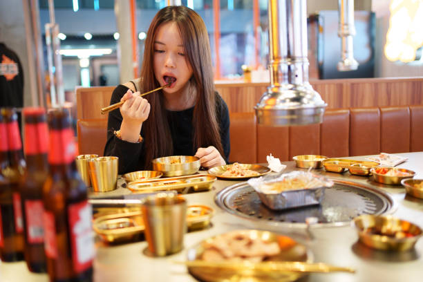 istock Young woman dining in restaurant 1832548086