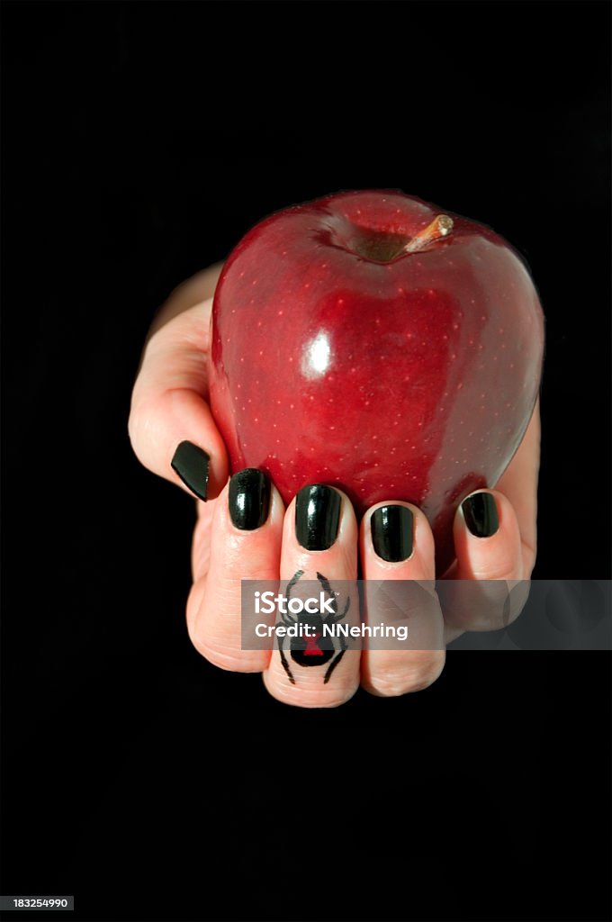 poison apple in hand Hand holding poison apple. Apple - Fruit Stock Photo