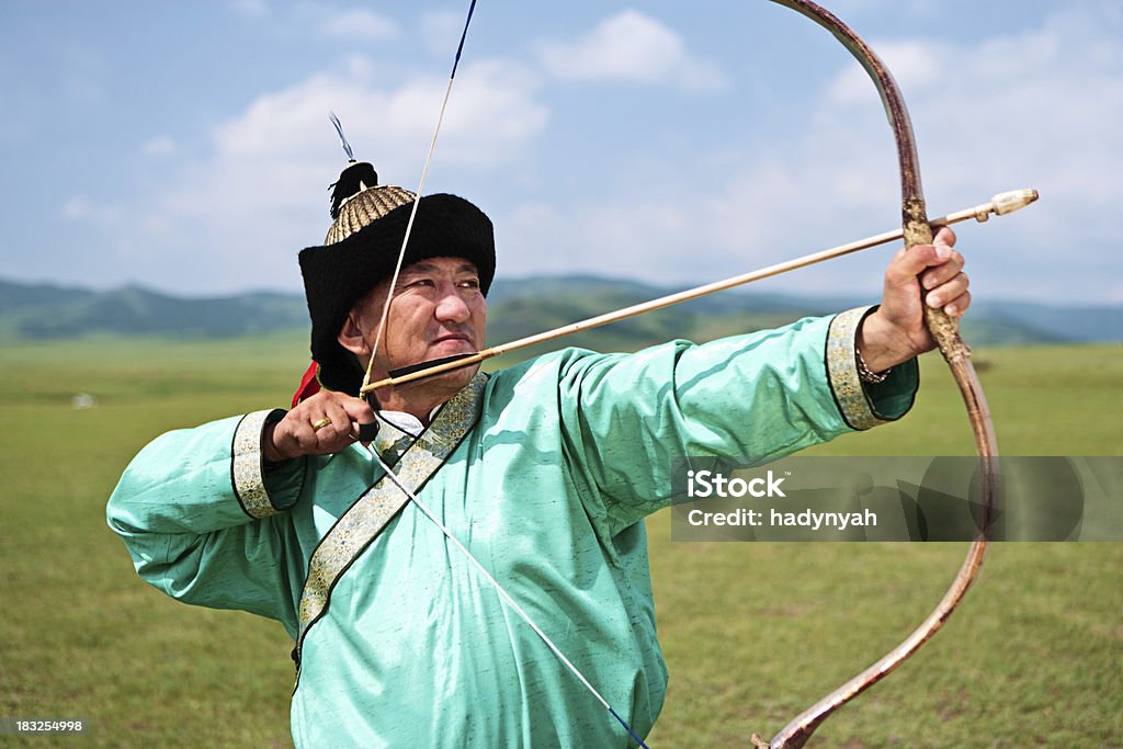 Mongolian archer Mongolian archer at Naadam festival, standing on the grass, the blue sky on the background.http://bem.2be.pl/IS/mongolia_380.jpg Accuracy Stock Photo