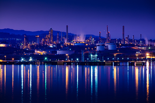 A large oil refinery and chemical plant on the Carquinez Strait in the San Francisco Bay Area is light up at night.