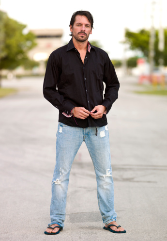 full length picture of a hispanic man looking at the camera