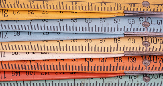 Old wooden folding meter ruler measuring centimeters, full frame