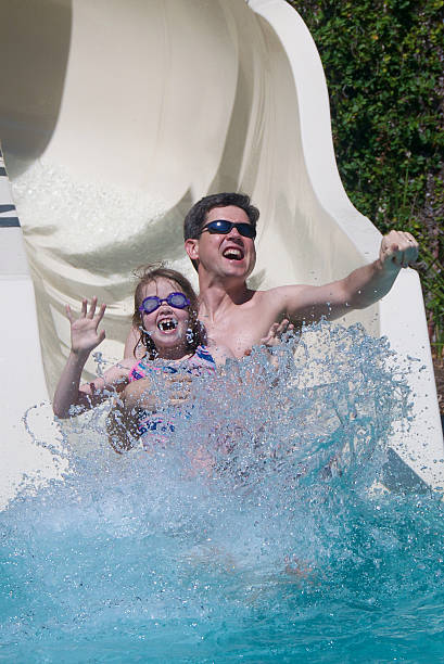 istock Girl and her father on a water slide 183257363