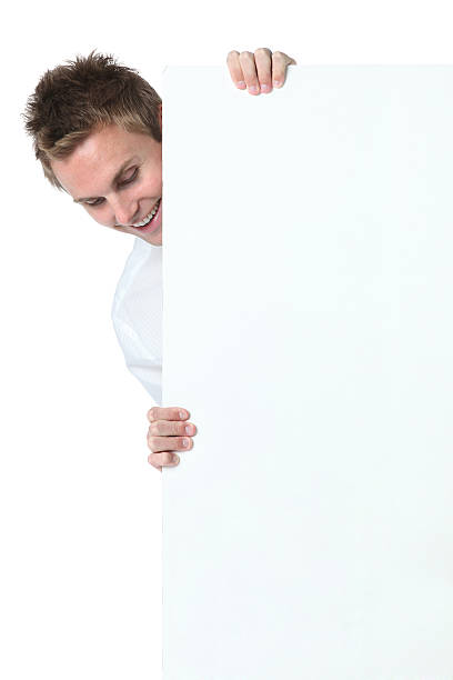 istock Businessman smiling behind a blank sign board 183257658