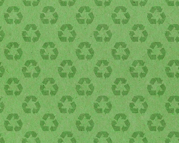 recycle symbol on green paper stock photo