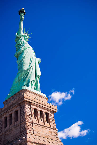 istock Statue of Liberty with blue sky and clouds 183258198