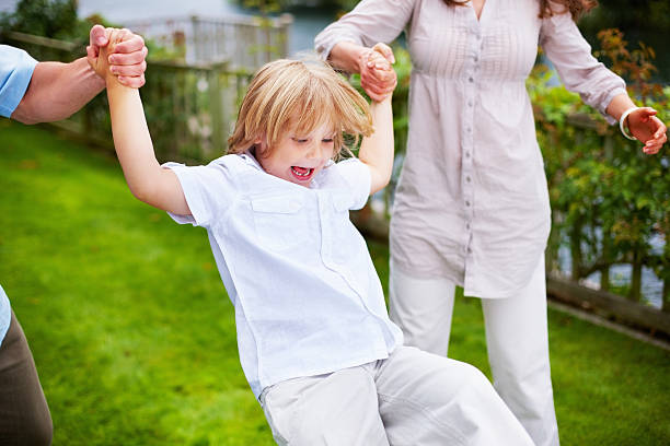 istock Cheerful little boy having fun with his parents 183258239