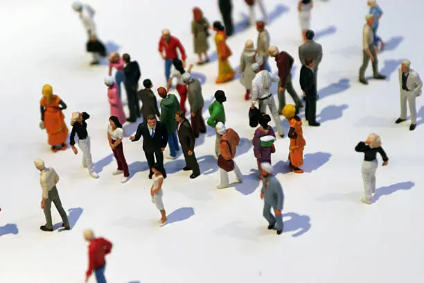Macro shot of mini business people standing - focus only on the business man in the middle west