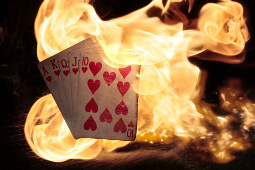 Royal flush hearts engulfed in fireActual cards and fire shot setup.  No digital manipulation.