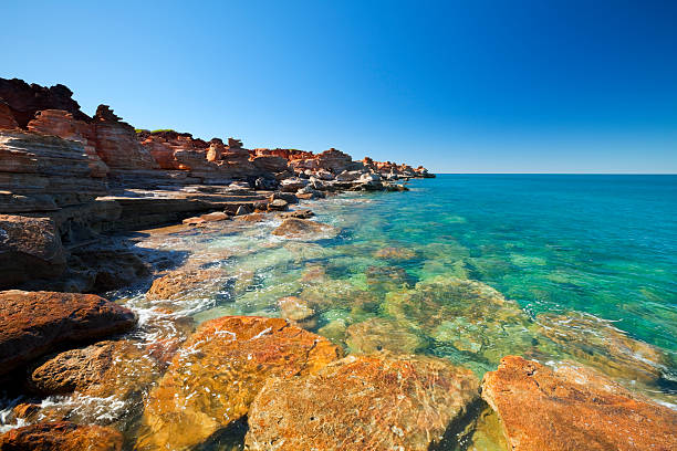 Red coastal cliffs at Gantheaume Point, Broome, Western Australia "Bright red cliffs and turquoise ocean at Gantheaume Point, Broome, Western Australia." kimberley plain photos stock pictures, royalty-free photos & images