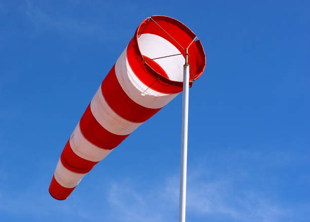 istock Red and white striped windsock being blown in the wind 183259148
