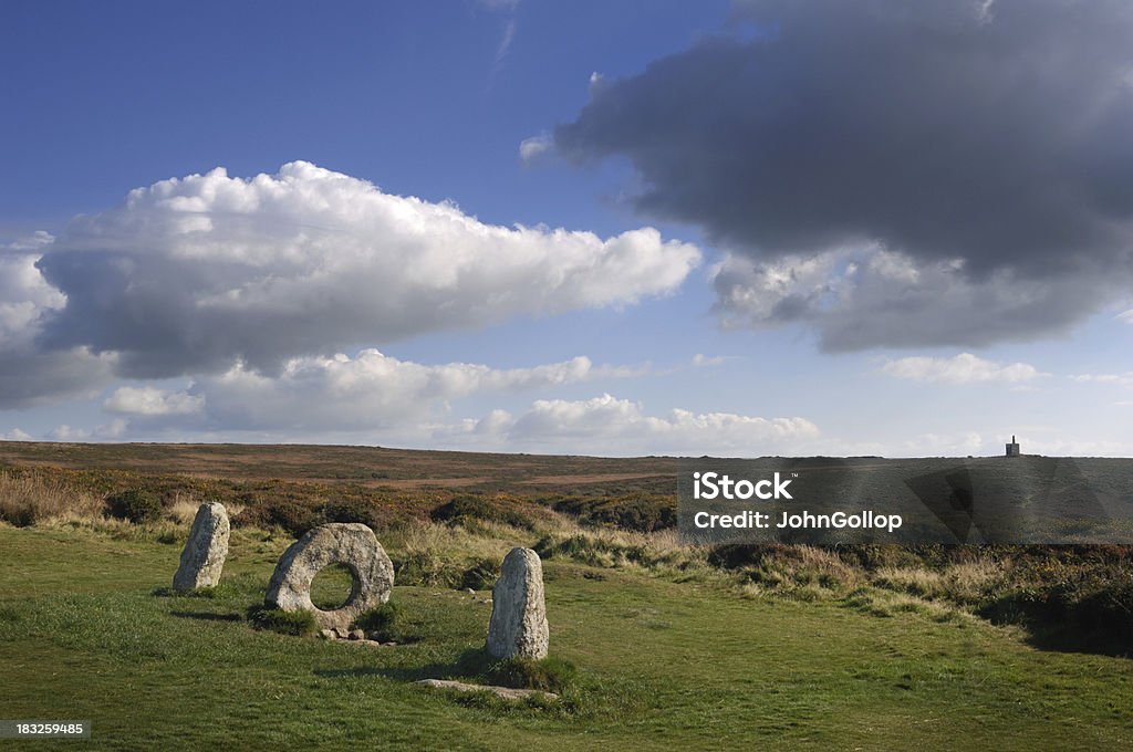 Men-An-Tol "Men-An-Tol standing stones, located in West Penwith, Cornwall. Note Ding Dong tin mine on the horizon." Cornwall - England Stock Photo