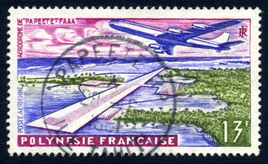 A fifty year old French Polynesian 13 Franc postage stamp issued in 1960 depicting the Papeete Airport.