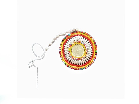 The white background in the picture is made up of multi-colored beads strung together to form a circle, in the center of which is a gold and si