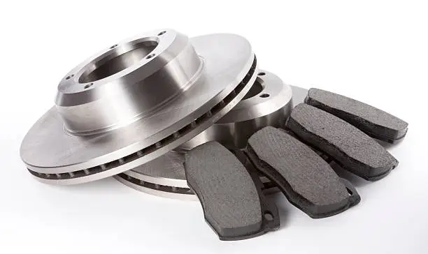Studio shot of a full set of front brake discs and pads on a white background.View Full Category: