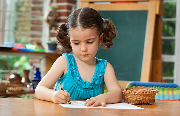 istock Cute little girl drawing at school 183260515
