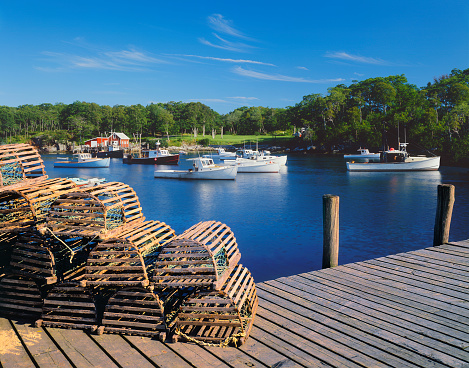 Wooden lobster traps and fishing boats of New Harbor, Maine
