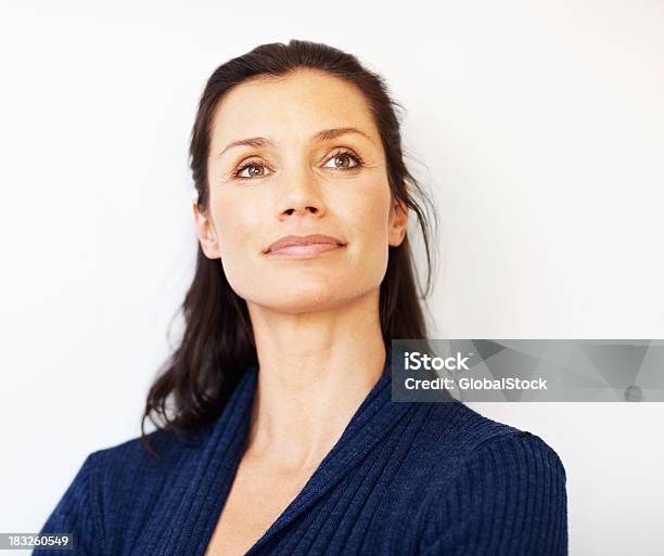 Relaxed Middle Aged Woman Looking Away At Copyspace Stock Photo - Download Image Now