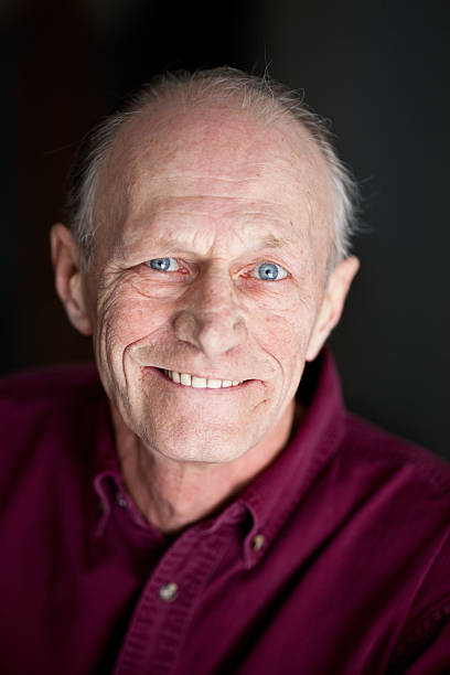istock Studio portrait of a elderly man on black 183260867