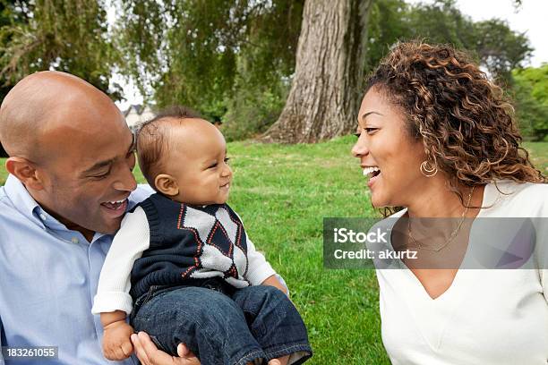 Happy African American Family Playing Baby Boy In The Park Stock Photo - Download Image Now