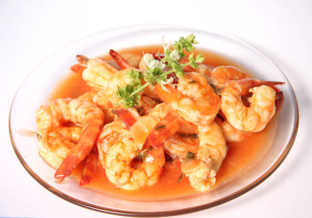 Shrimps in tomato garlic sauce with basil flowers
