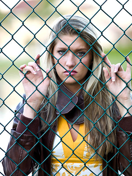 istock Sad girl behind the fence 183261561