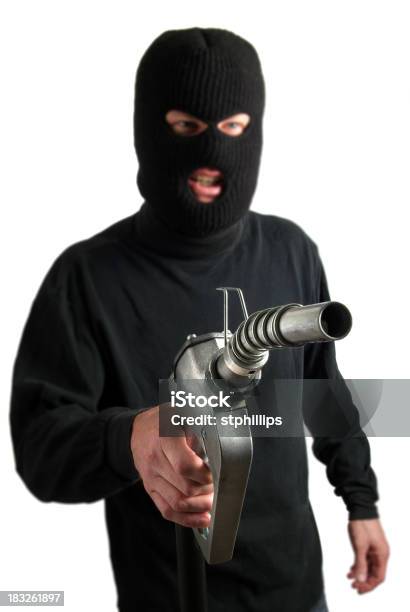 Foto de Ploceus Robber Segurando Um Bocal Da Bomba De Combustível e mais fotos de stock de Ladrão