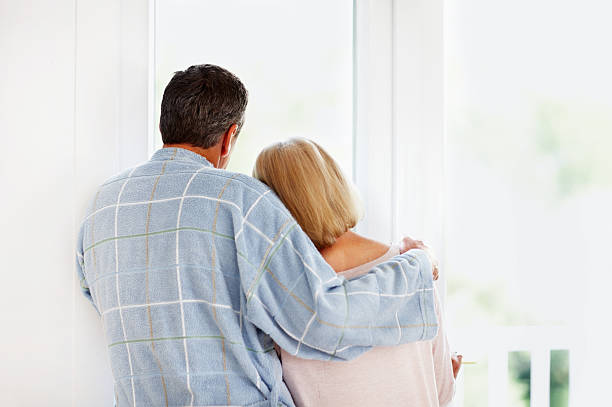 istock Romantic mature couple looking through glass window 183262207