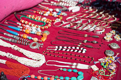 Nepali street seller - selling jewellery in Mount Everest National Park, Nepal. This is the highest national park in the world, with the  entire park located above 3,000 m ( 9,700 ft). This park includes three peaks higher than 8,000 m, including Mt  Everest. Therefore, most of the park area is very rugged and steep, with its terrain cut by deep rivers and  glaciers. Unlike other parks in the plain areas, this park can be divided into four climate zones because of the  rising altitude. The climatic zones include a forested lower zone, a zone of alpine scrub, the upper alpine zone  which includes upper limit of vegetation growth, and the Arctic zone where no plants can grow.http://bem.2be.pl/IS/nepal_380.jpg