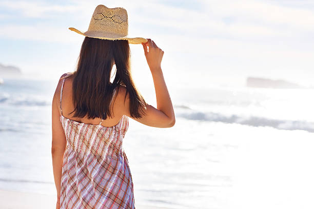 istock Young woman looking at sunset on the beach 183262295